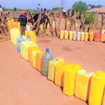The daily struggle for basic dignity. Families queue for hours under intense conditions just to fill basic water containers.